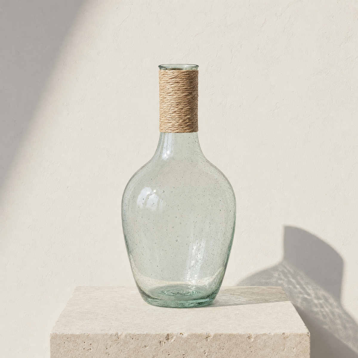 Rill clear recycled glass bottle vase, medium, with a raffia-wrapped neck